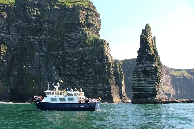 A cliffs cruise passing the sea stack at the foot of the Cliffs of Moher