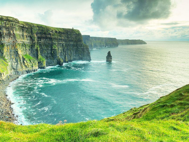 The bay below the Cliffs of Moher, with the sea stack at the far end of the wall