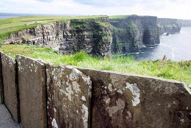 The Liscannor flagstone wall along the cliff edge with the Cliffs of Moher beyond