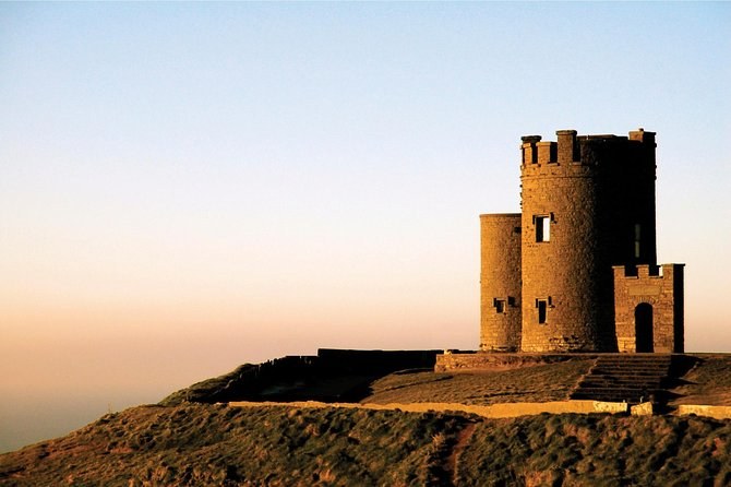 O'Brien's Tower on the high point of the Cliffs of Moher, silhouetted at sunset